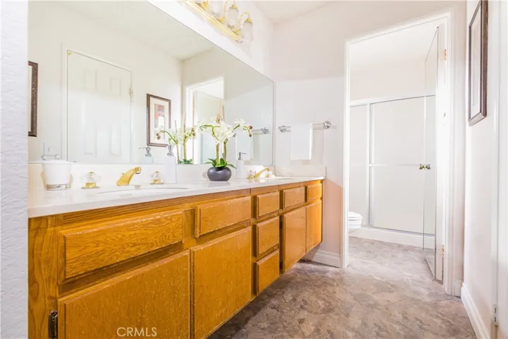 Master bathroom with double sinks and separate shower and toilet room.
