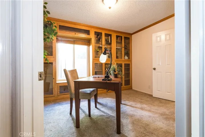 Alternate view of the staged office with crown molding and built in cabinets.