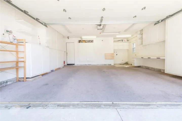 Finished garage with built-ins for extra storage.