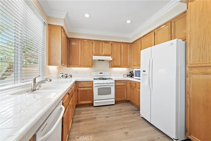 The large kitchen boasts an abundance of cabinets and counter space. It's light and bright during the day and offers recessed lighting and under cabinet lighting for the evenings.