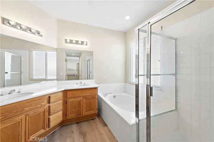 The master bathroom offers his and hers closets (one being a walk-in), dual sinks and separate shower and soaking tub.
