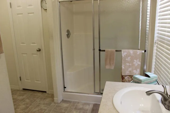 View of walk-in shower in master bath.