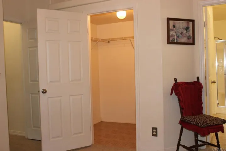 View of large walk-in closet in master bedroom