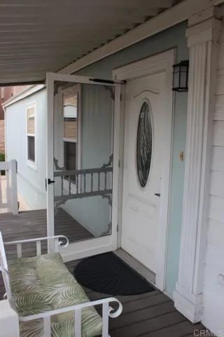 Close up of porch deck and attractive front door to home.