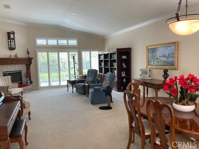 Living and dining rooms with high ceilings & plantation shutters.