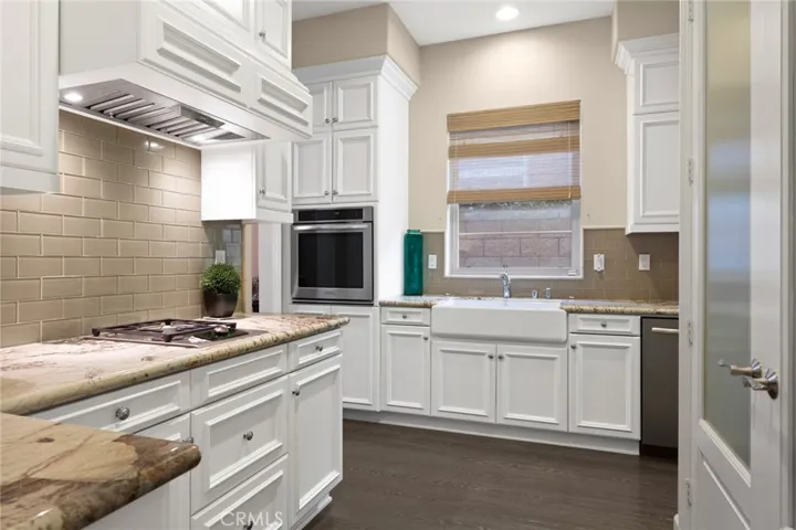 Prep kitchen has large farm sink, burner cooktop, 2nd oven, dishwasher and large pantry for storage.