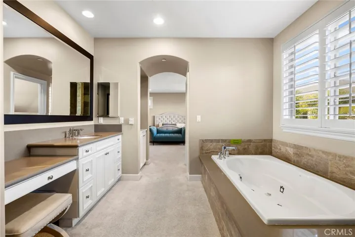 Master bath offers dual vanities, tub, shower and private washroom