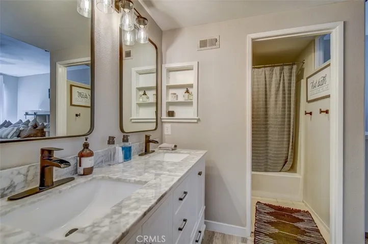 Beautiful New Cabinets, Marble Top Mirrors and Hardware. Looking into Toilet and Shower/Bath
