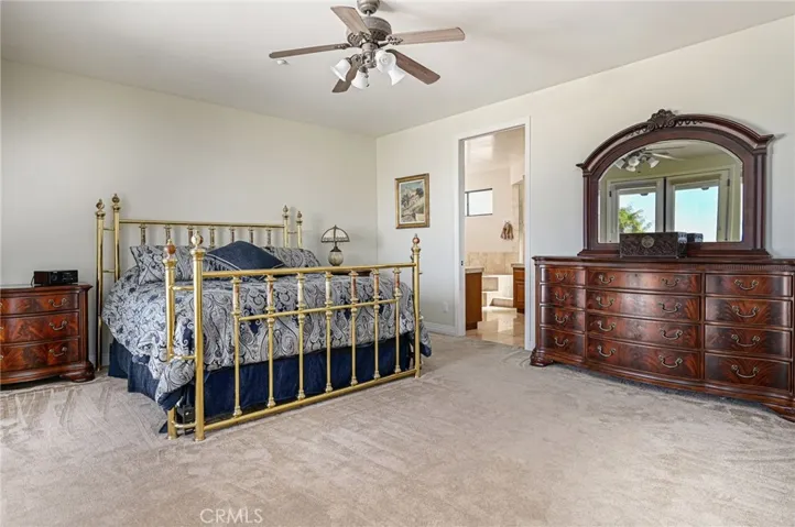 Primary bedroom with sunset and mountain views