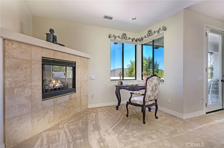 Primary bedroom retreat area with fireplace and views