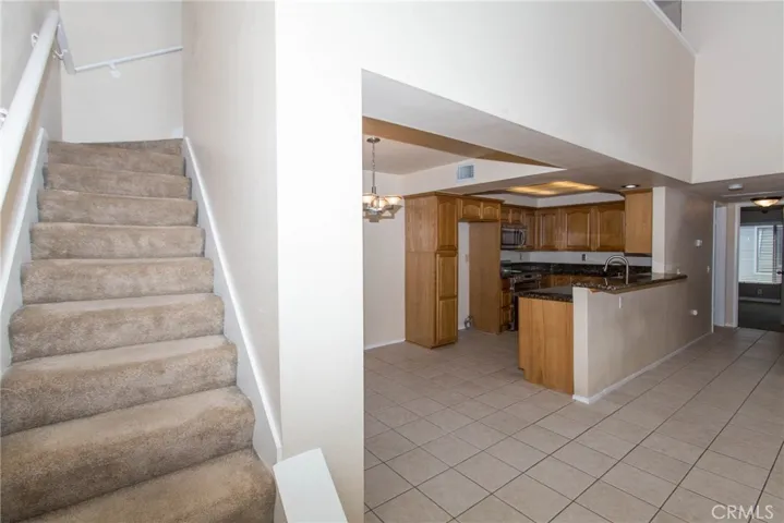 stair to upper loft looking at the dining room and kitchen