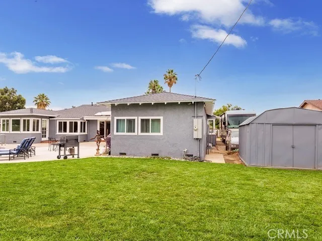 Rear of house, lawn and storage shed