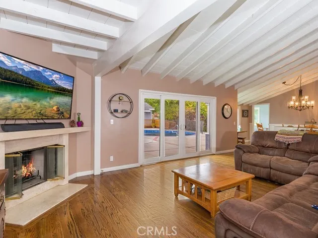 Living room with fireplace and high, open beamed ceilings