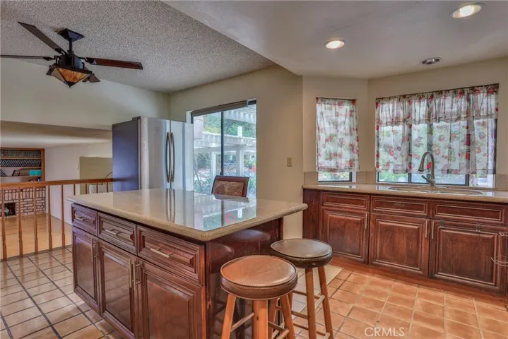 Kitchen with eating area. The stainless steel refrigerator is a second fridge, that space can be used for a table and chairs.