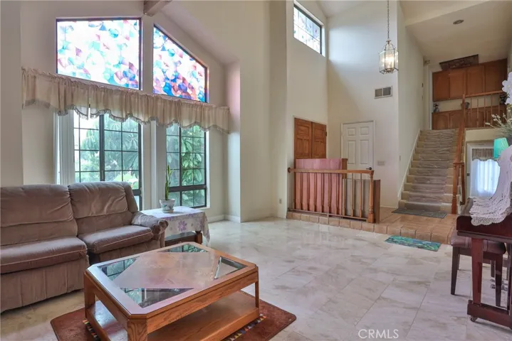 View of the front door and staircase from living room