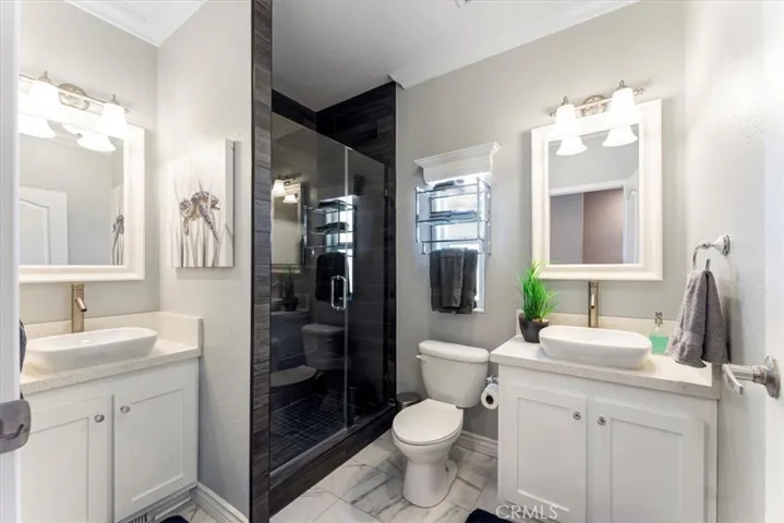 Upstairs bathroom with separate dual sinks.