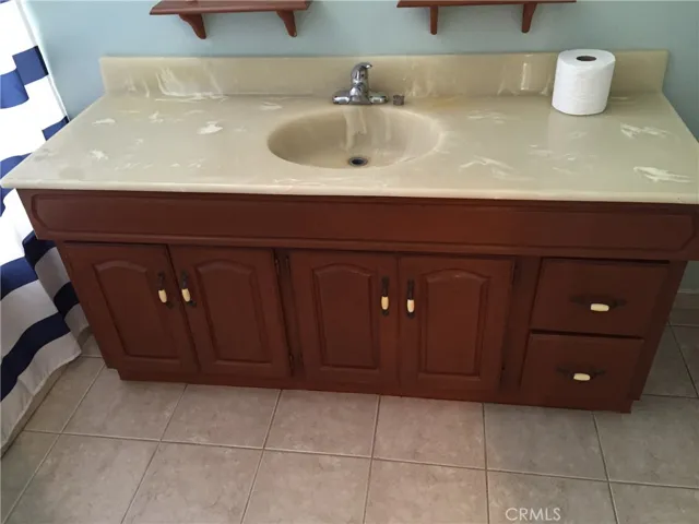 Modern bathroom with tile floor, spacious vanity and Corian countertop