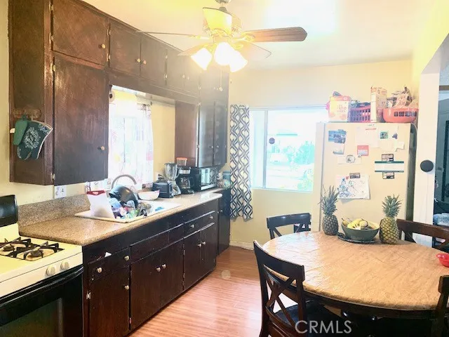 Kitchen also has multiple windows, granite countertop and ceiling fan. Refrigerator and Stove stay, too
