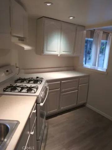 Another view of this very cute kitchen with eating bar, and brand new flooring.