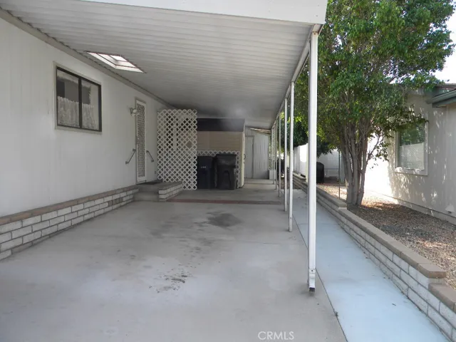 Carport with two sheds in back