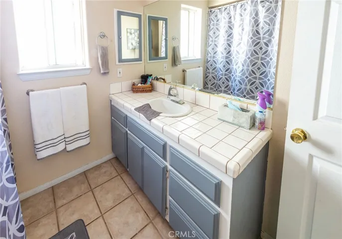 Secondary restroom with deep soaking tub in shower