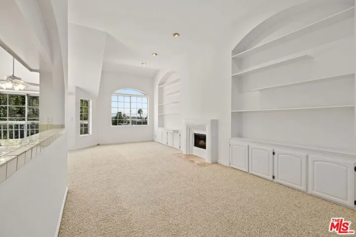 Living room with soaring ceilings & a gas fireplace