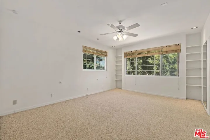 Generous primary suite with ceiling fan