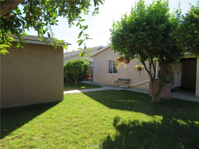View from opposite side of rear yard facing the back of the home and shed