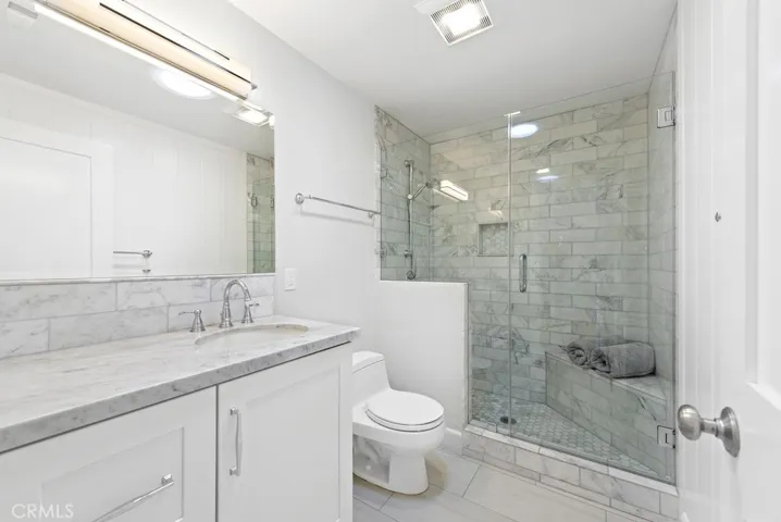 Gorgeous hall bath with marble walk-in shower.