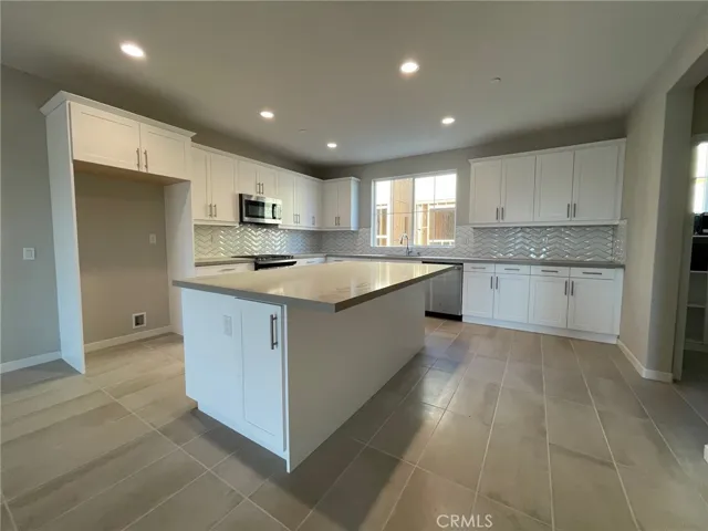 Upgraded flooring, counter and backsplash surfaces