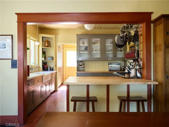 Kitchen with Carrera marble and wood counters. Door at rear of kitchen leads to backyard
