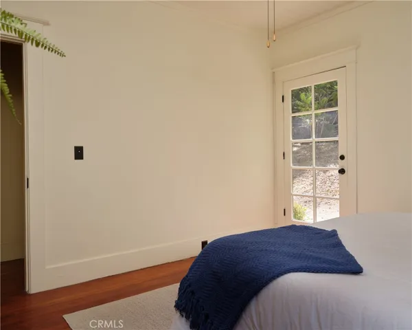 Main level bedroom with door to backyard