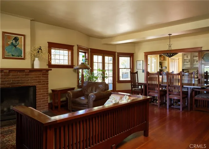 Living and dining areas with French doors to side yard and pergola