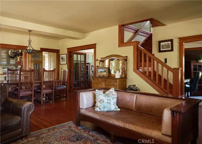 Living and dining areas with stairs to upper 2 bedrooms and full bath