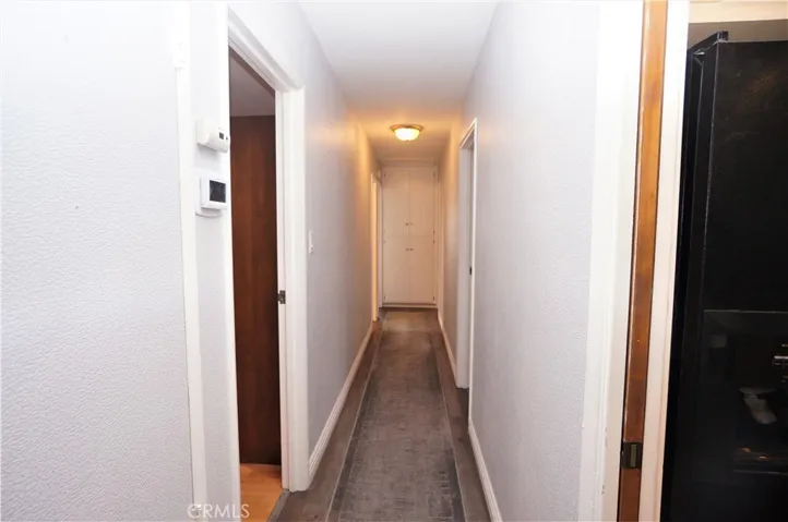Hall to the bedrooms and bathrooms. Kitchen Pantry on the left.