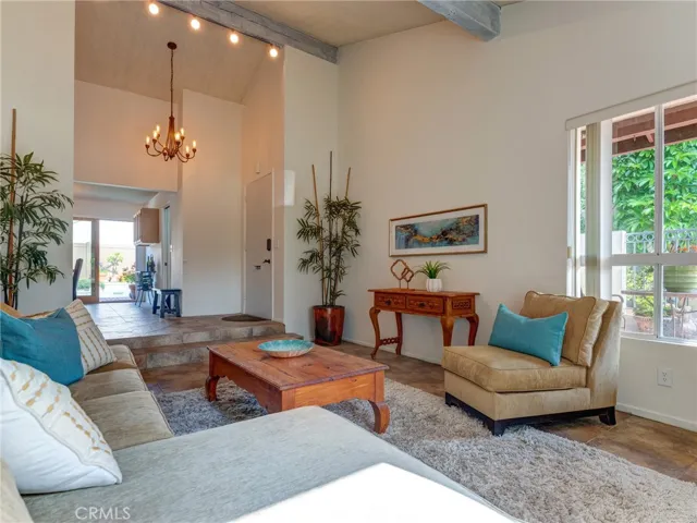 Large living room with vaulted beamed ceilings.