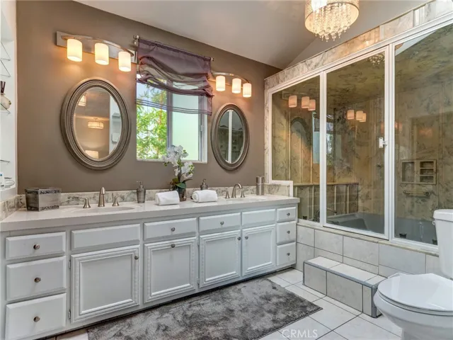 Primary bathroom with dual sinks, steam shower and huge walk-in closet.