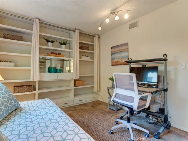 Downstairs bedroom with built in cabinetry.