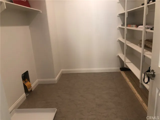 Large inside laundry room with built-in shelves.
