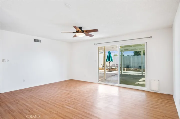 Living room with ceiling fan & access to back yard