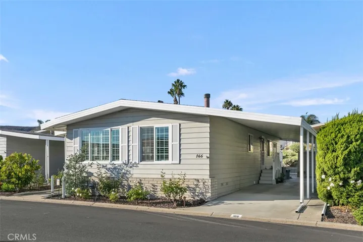 Carport has room for golf cart and two cars.