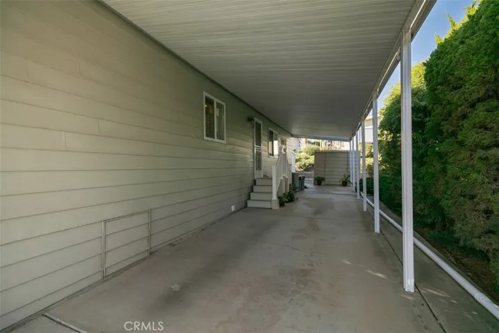 Carport with a second storage shed.