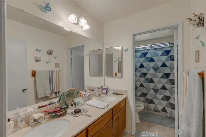 Hall bath with separate toilet and shower area.