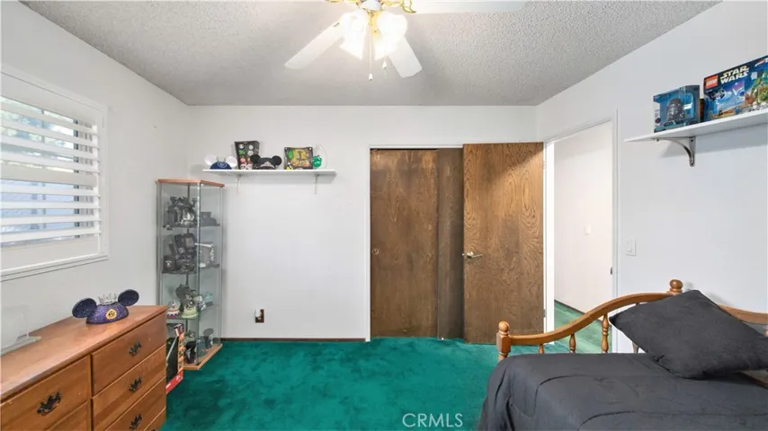 Bedroom #3 with Plantation Shutters and ceiling fan