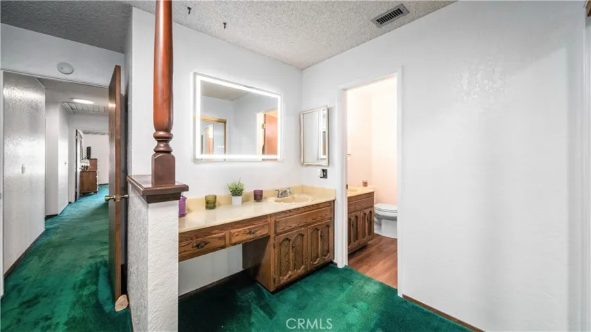 Primary bathroom with LED lighted mirror, 2 sinks and vanity