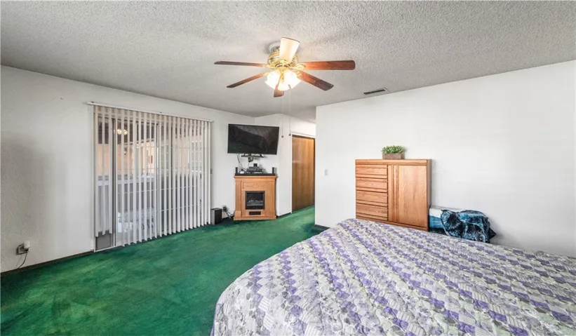 Primary bedroom with slider to patio with relaxing spa