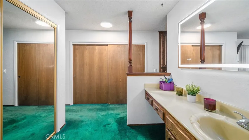 Primary bathroom with view of two closets