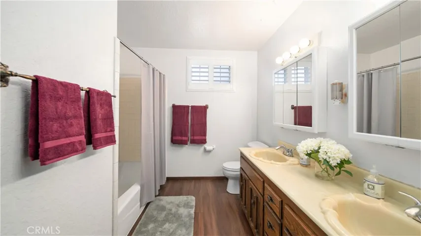 Hallway bathroom with dual sinks and lots of counter space