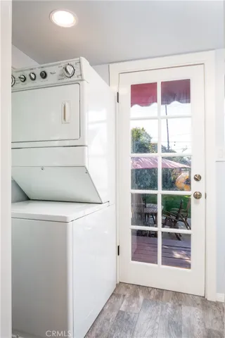 Laundry room off of kitchen with a door to the backyard