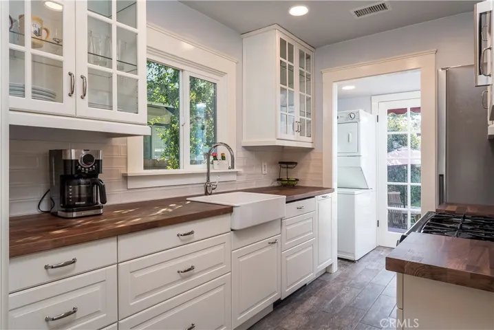 Totally remodeled kitchen with new flooring, cabinets, sink, and countertops